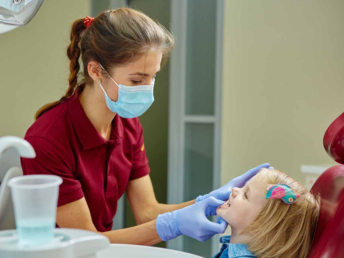 Child receiving dental care during a pediatric dental visit